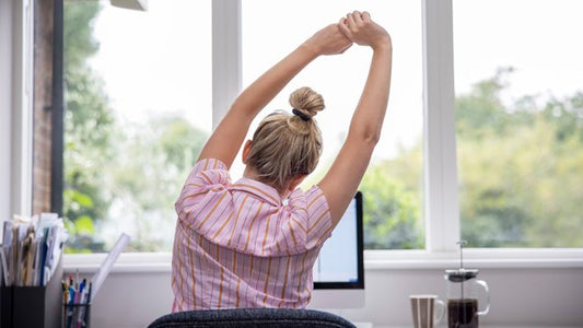 Sore From a Long Day at Work? Try These 13 Desk Yoga Poses to Fight Stiffness